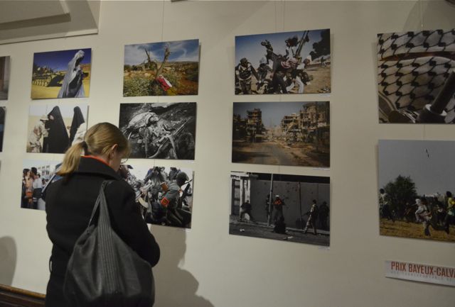 Prix Bayeux exhibited photographs from winners of the award during the evening. [Caroline Schmitt]